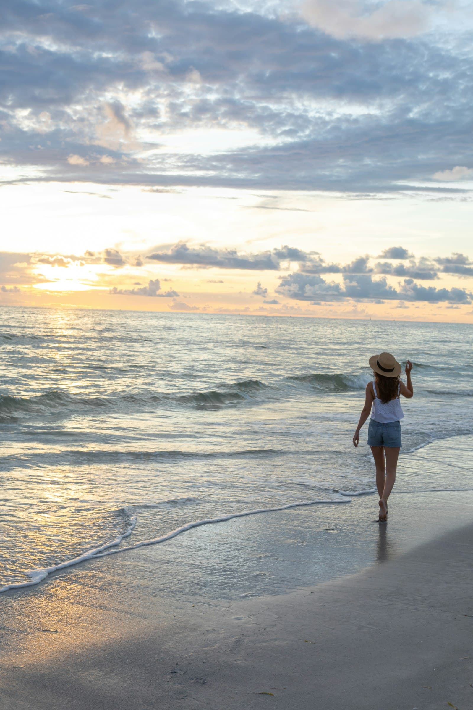 Woman walking peacefully along the seashore