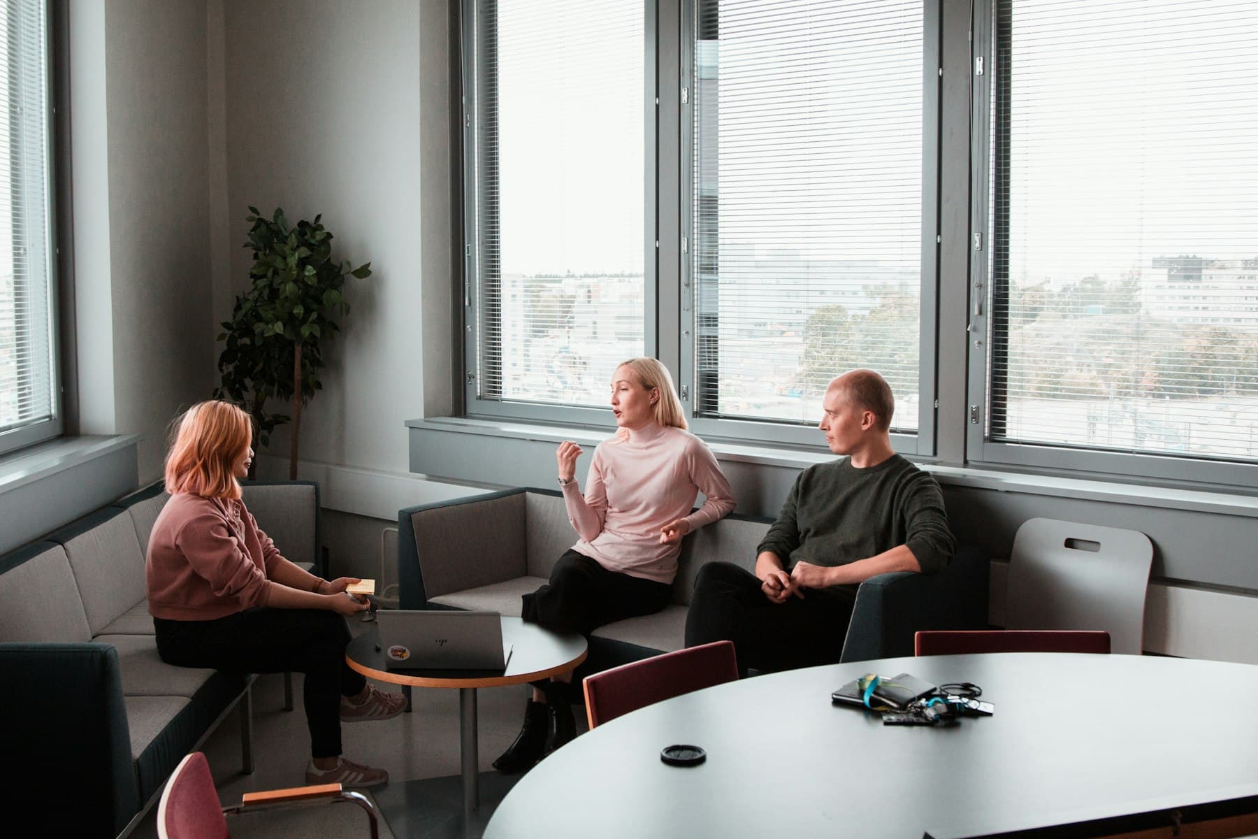 Two people in a relaxed conversation in a bright, comfortable office