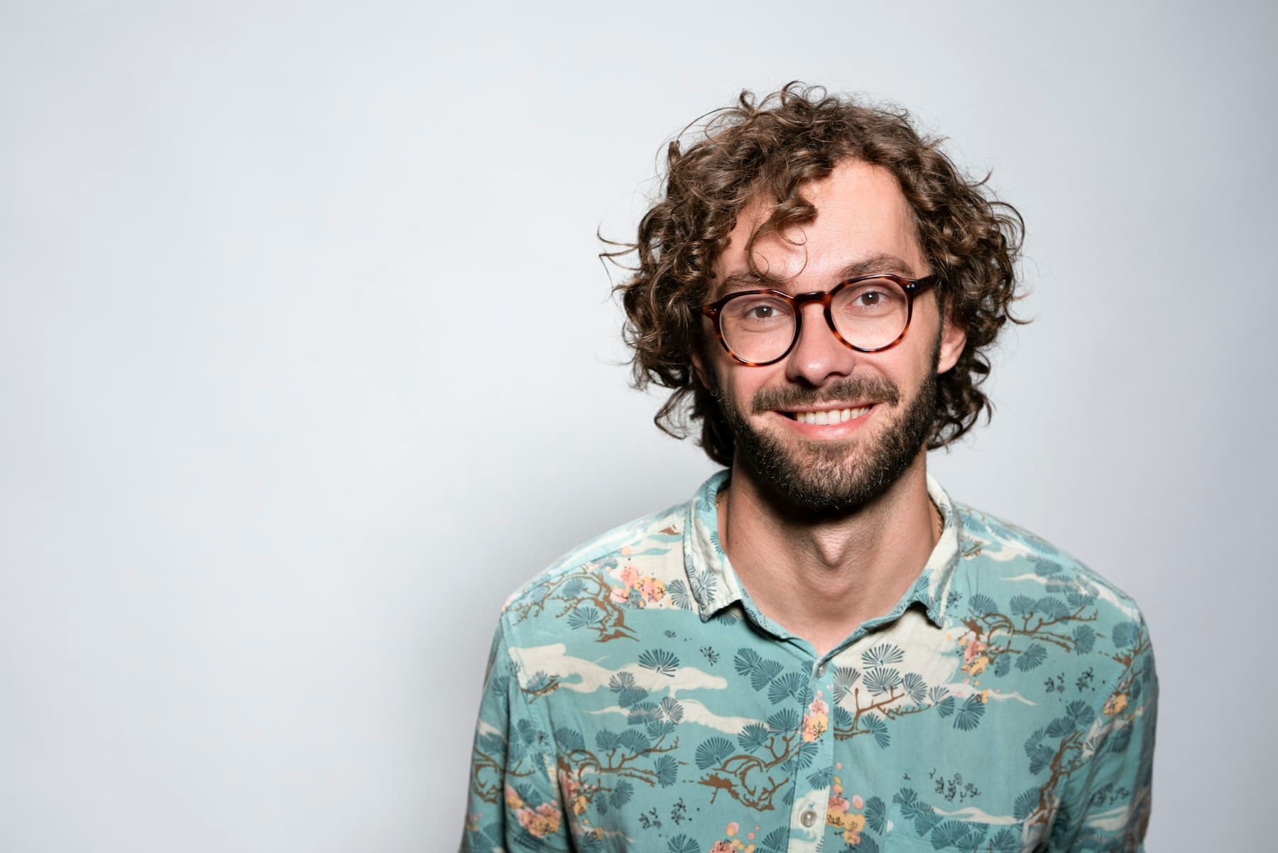 Smiling man with glasses and a beard