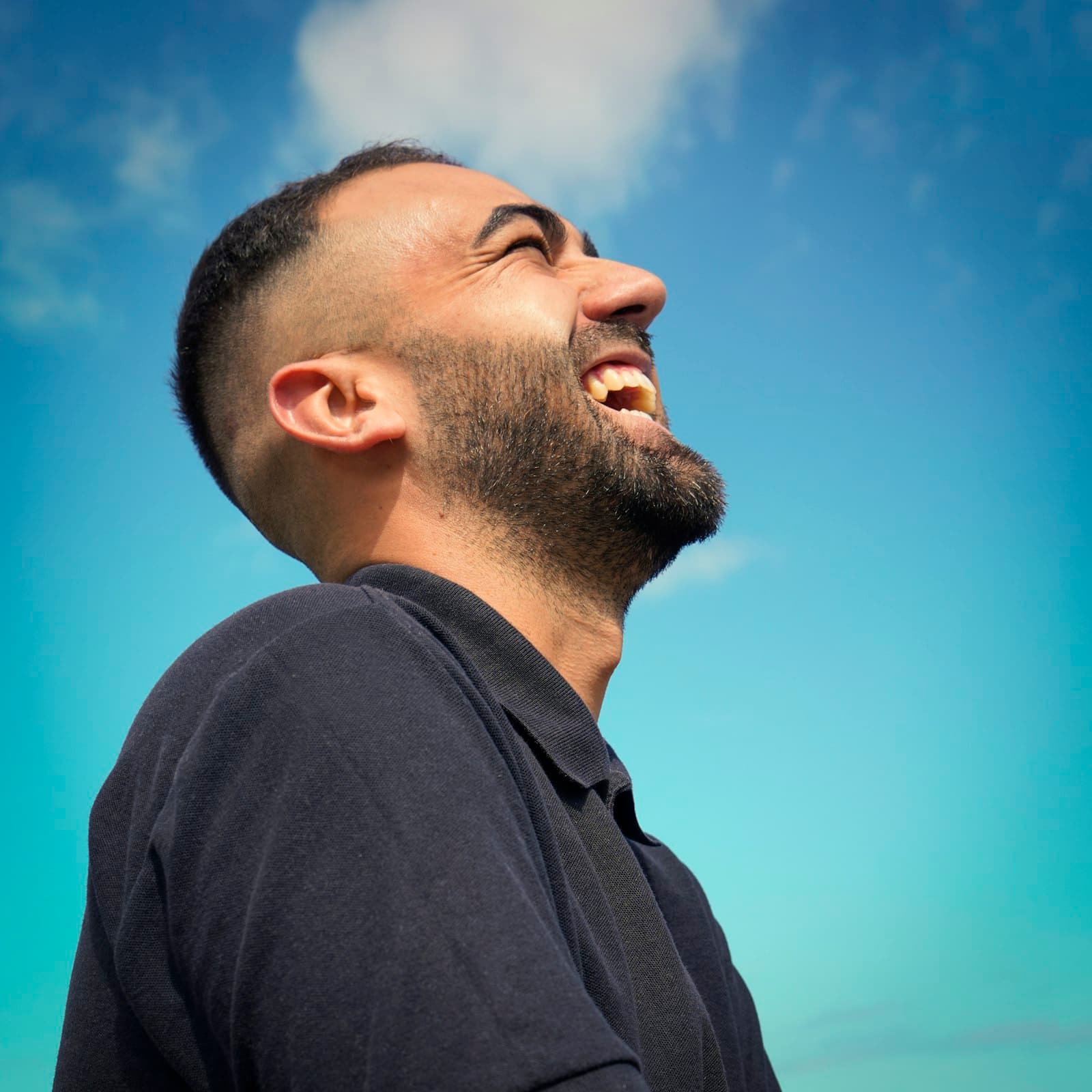 Portrait of a smiling man in a dark collared shirt