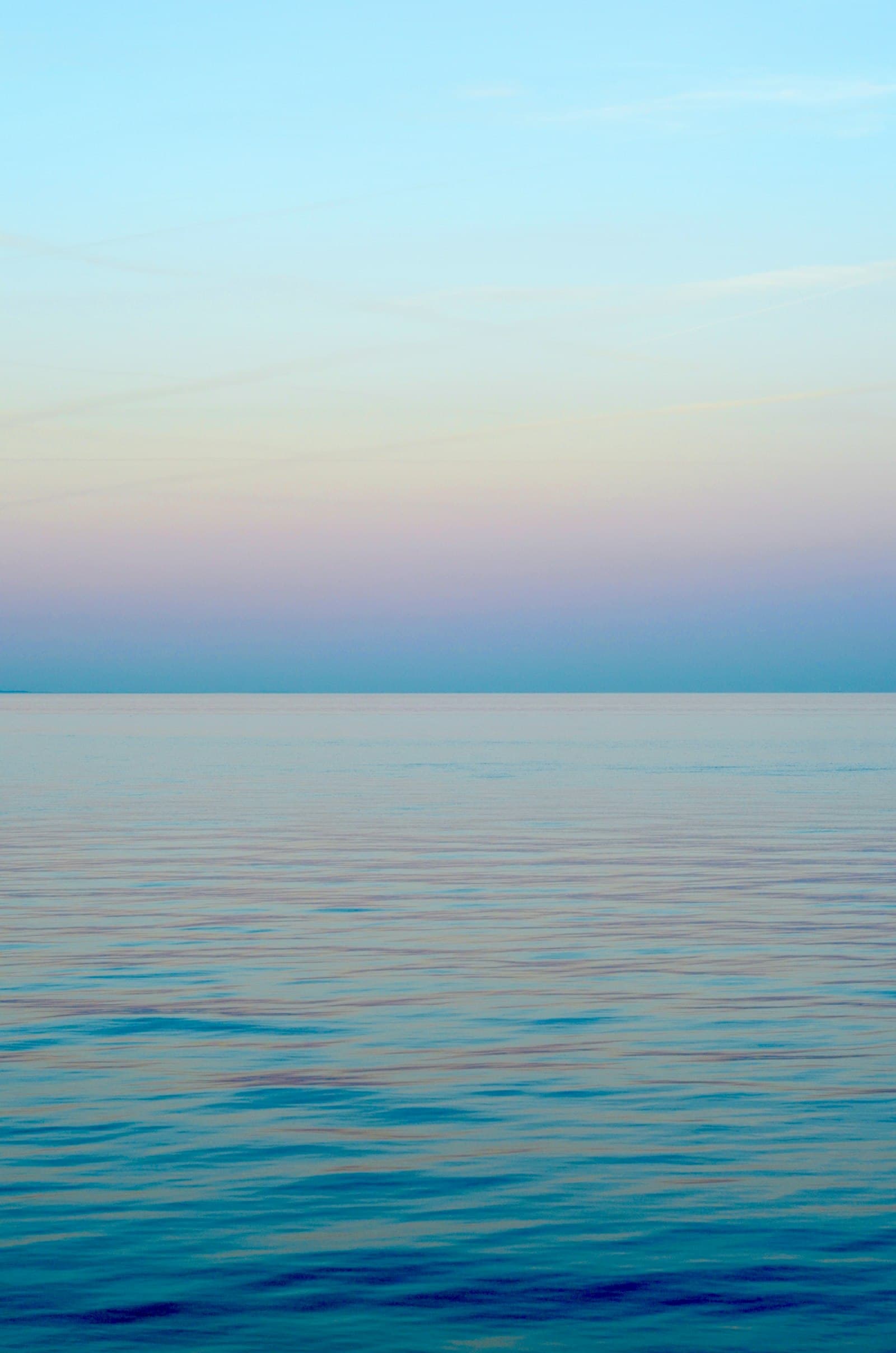 Wide view of open water under a soft sky